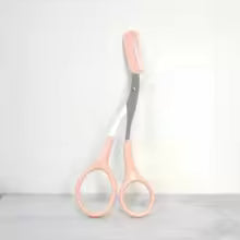 Pink eyebrow trimming scissors with built-in comb